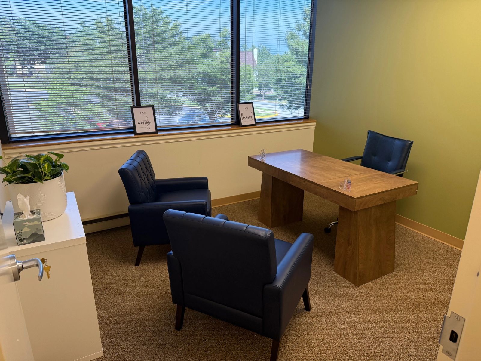 Private suite with a desk and seating at The Self Care Sanctuary Suites in Laurel, Maryland